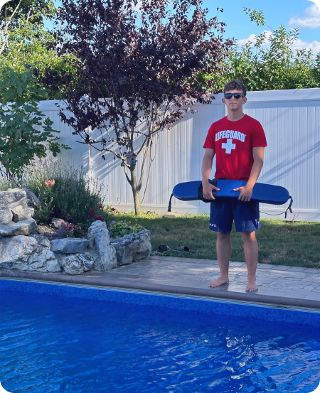 a boy standing by the pool